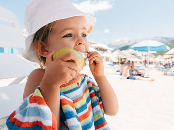 Portrait of cute girl standing at beach