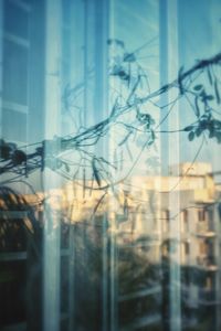 Close-up of glass window against sky