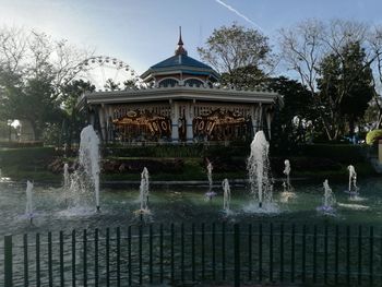 Fountain in front of built structure against sky