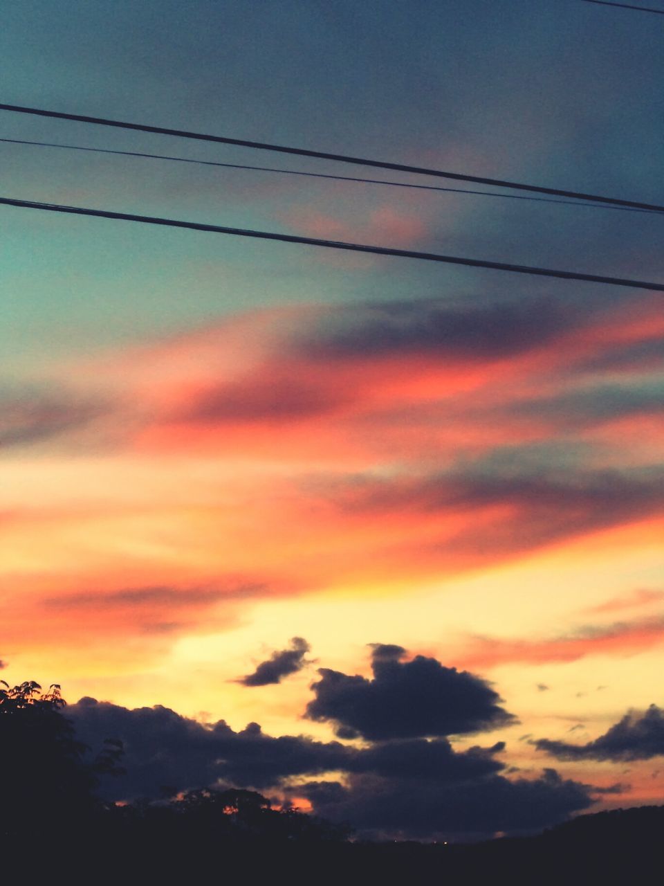 sunset, sky, scenics, cloud - sky, beauty in nature, silhouette, orange color, tranquility, tranquil scene, power line, low angle view, nature, dramatic sky, cloud, idyllic, cloudy, majestic, moody sky, outdoors, dusk