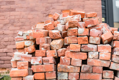 Stack of stones against brick wall