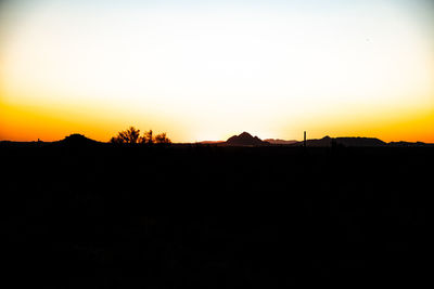Scenic view of silhouette landscape against sky during sunset