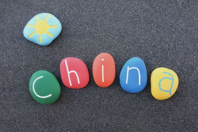 Directly above shot of china text on colorful pebbles at table