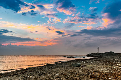 Scenic view of beach against sky during sunset