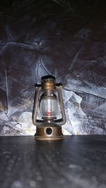 High angle view of lantern on table against wall