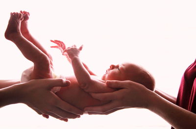 Close-up of newborn against white background