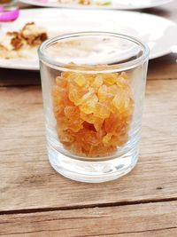 Close-up of brown sugar in glass on table