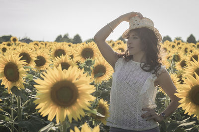 Low angle view of girl standing on field against clear sky