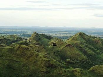 Scenic view of mountains against cloudy sky