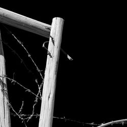 Low angle view of wooden fence against sky