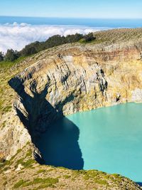 High angle view of rock formation in sea against sky
