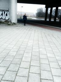 Woman walking on footpath