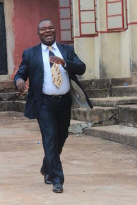 Full length of a man standing against building