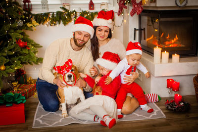 Portrait of siblings with teddy bear at home