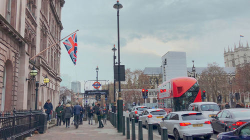 Crowd on city street against sky