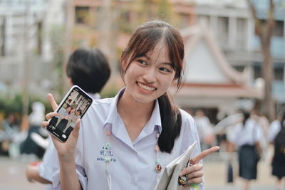 Portrait of a smiling young woman in city