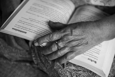 Midsection of woman holding book with text