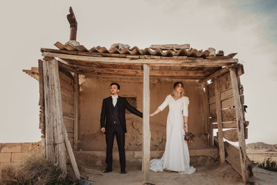 Couple standing against wall