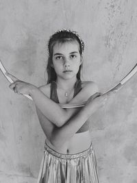 Portrait of girl standing against wall