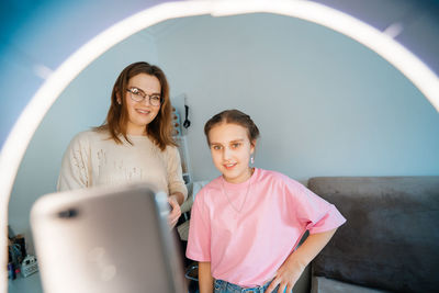 Mother and daughter record video use smartphone