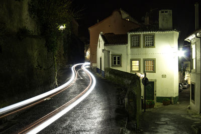 Street amidst illuminated buildings at night