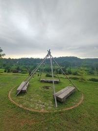 Traditional windmill on field against sky