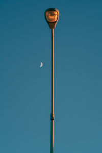 Low angle view of street light against clear blue sky