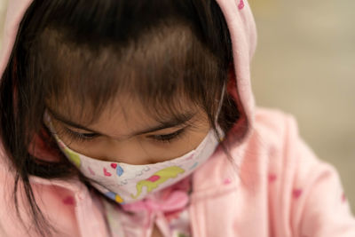 Close-up of girl wearing mask outdoors