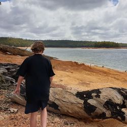 Rear view of woman looking at sea shore