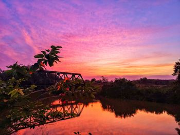 Scenic view of lake against romantic sky at sunset