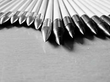 Close-up of arrows on table