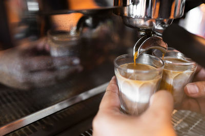 Worker works with a coffee machine