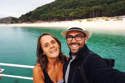 Portrait of happy young couple on boat at cies islands