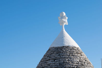 Low angle view of white building against clear blue sky