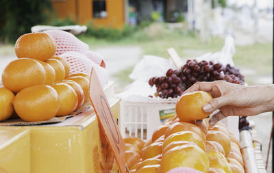 Close-up of hand holding fruits at market stall