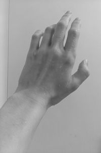 Close-up of person hand on wet floor