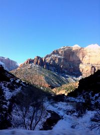 Scenic view of mountains against clear blue sky