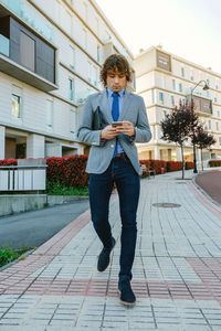 Full length portrait of man standing in city