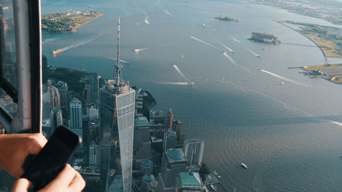 High angle view of man and cityscape on sea
