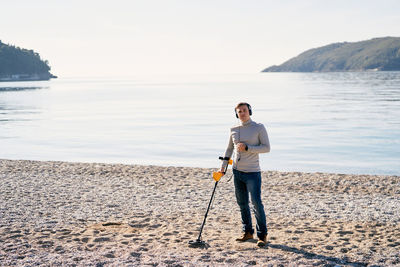 Rear view of man standing at beach