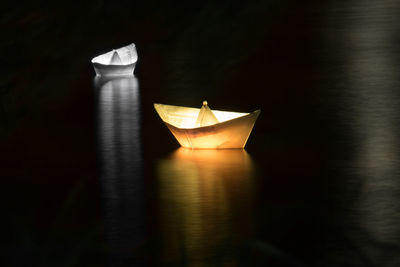 Close-up of illuminated paper boat in water