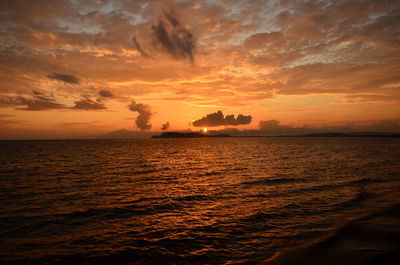 Scenic view of sea against romantic sky at sunset