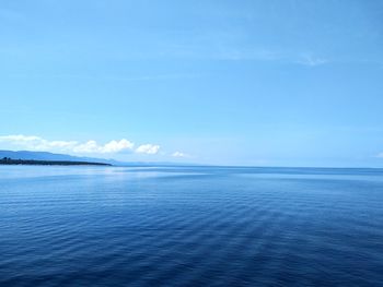 Scenic view of sea against blue sky