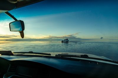 Scenic view of sea seen through car windshield