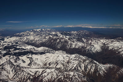 Aerial view of dramatic landscape against sky during winter