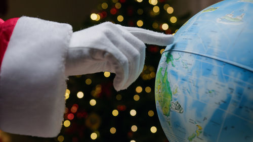 Cropped hand of woman holding crystal ball