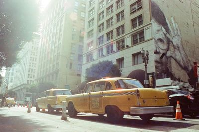 Cars on street by buildings in city