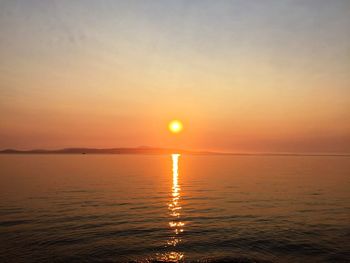 Scenic view of sea against romantic sky at sunset