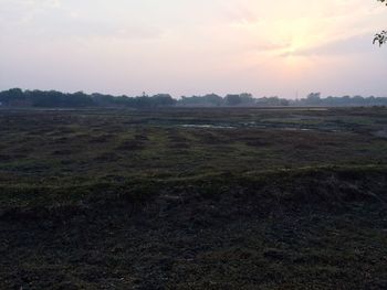 Scenic view of landscape against sky at sunset