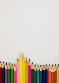 Close-up of multi colored pencils against white background